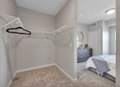 Thumbnail 10 of 98 - A bedroom with a bed, dresser, and a hanger on the wall.