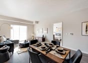 Thumbnail 14 of 98 - A modern dining room with a wooden table set for four.