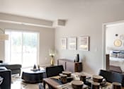 Thumbnail 15 of 98 - A modern living room with a dining table set for four.