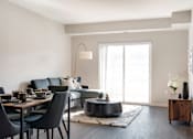 Thumbnail 16 of 98 - A modern dining room with a black table and chairs.