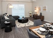 Thumbnail 17 of 98 - A modern living room with a dining table set for two.