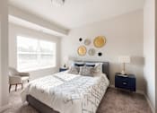 Thumbnail 20 of 98 - A bedroom with a bed, chair, and wall decor.