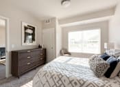 Thumbnail 21 of 98 - A bedroom with a large bed and a dresser.