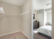 Thumbnail 22 of 98 - A bedroom with a white bed and a white closet.