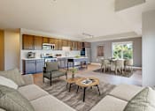 Thumbnail 28 of 98 - A modern living room with a kitchen in the background.