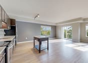 Thumbnail 34 of 98 - A spacious kitchen and dining area with wooden floors and large windows.