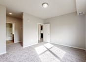 Thumbnail 36 of 98 - A spacious room with a carpeted floor and a window on the right side.
