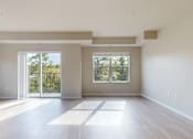 Thumbnail 39 of 98 - A large, empty room with a sliding glass door leading to a balcony.