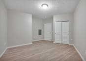 Thumbnail 51 of 98 - A room with a white door and a white closet.