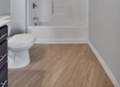 Thumbnail 53 of 98 - A white toilet sits next to a walk-in shower in a bathroom.