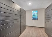 Thumbnail 59 of 98 - A hallway with a row of lockers on the left and a TV screen on the right.