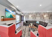 Thumbnail 65 of 98 - A modern living room with a flat screen TV mounted on a brick wall.