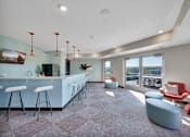 Thumbnail 78 of 98 - A modern bar area with a long counter and stools.