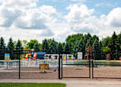 Thumbnail 97 of 98 - A playground with a fence and a sign in the background.