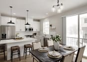 Thumbnail 2 of 16 - A modern kitchen with a dining table set for two.