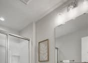 Thumbnail 9 of 16 - A white bathroom with a toilet, sink, and a mirror.