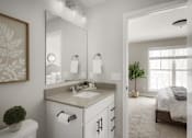 Thumbnail 10 of 16 - A bathroom with a toilet, sink, and mirror.