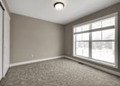 Thumbnail 16 of 16 - A room with a carpeted floor and a window.