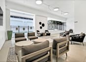 Thumbnail 4 of 18 - A white room with a couch, chairs, and a table at The Palms on Main, Columbia, 29201