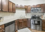 Thumbnail 13 of 24 - Large open kitchen with stainless steel appliances at The Residence at Marina Bay, Irmo, SC