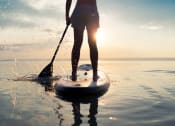 Thumbnail 19 of 24 - a person standing on a paddle board in the water at The Residence at Marina Bay, Irmo, 29063