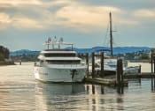 Thumbnail 25 of 27 - a large white yacht is docked next to a small white boat