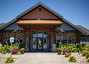 Thumbnail 34 of 53 - the front entrance of a brick building with a porch and a sidewalk at The Brix Apartments, Spokane Valley, WA, 99037