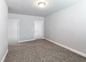 Thumbnail 27 of 53 - A room with two doors and carpeted floor.at The Brix Apartments, Washington