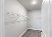 Thumbnail 33 of 53 - A white closet with a carpeted floor and a white door.at The Brix Apartments, Spokane Valley, Washington