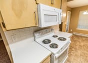 Thumbnail 33 of 73 - A white stove and microwave in a kitchen at Graymayre Crossing Apartments, Spokane, WA, 99208
