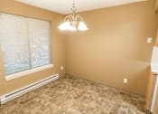 Thumbnail 34 of 73 - A room with a window, tiled floor, and a chandelier at Graymayre Crossing Apartments, Spokane, WA, 99208