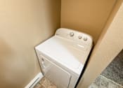 Thumbnail 40 of 73 - A white washing machine in a small space at Graymayre Crossing Apartments, Spokane, WA