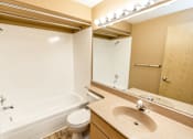 Thumbnail 42 of 73 - A bathroom with a white tub, toilet, and sink at Graymayre Crossing Apartments, Spokane, WA, 99208