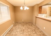 Thumbnail 47 of 73 - A room with a tiled floor and a chandelier hanging from the ceiling at Graymayre Crossing Apartments, Spokane, WA