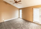Thumbnail 48 of 73 - A room with a ceiling fan and carpeted floor at Graymayre Crossing Apartments, Spokane, WA