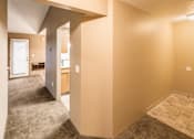 Thumbnail 49 of 73 - A hallway with a carpeted floor and a door on the right side at Graymayre Crossing Apartments, Spokane, WA, 99208