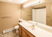Thumbnail 50 of 73 - A bathroom with a toilet, sink, mirror, and lights at Graymayre Crossing Apartments, Spokane, WA, 99208