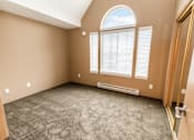 Thumbnail 52 of 73 - A room with a carpeted floor, a window with blinds, and a door at Graymayre Crossing Apartments, Spokane