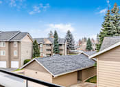 Thumbnail 11 of 73 - A row of houses with a clear blue sky above them at Graymayre Crossing Apartments, Spokane, WA, 99208