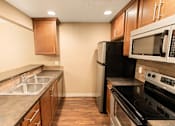 Thumbnail 57 of 73 - A kitchen with a black refrigerator and stove at Graymayre Crossing Apartments, Spokane, WA, 99208