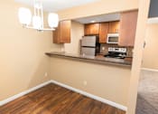 Thumbnail 61 of 73 - A kitchen with wooden floors and a stainless steel refrigerator at Graymayre Crossing Apartments, Spokane, WA, 99208
