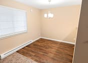 Thumbnail 62 of 73 - A room with wooden flooring and a window with blinds at Graymayre Crossing Apartments, Spokane, WA, 99208