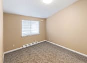 Thumbnail 69 of 73 - A room with a window and carpeted floor at Graymayre Crossing Apartments, Spokane, 99208