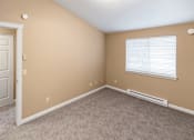 Thumbnail 70 of 73 - A room with a white door, carpeted floor, and a window with blinds at Graymayre Crossing Apartments, Spokane, WA, 99208