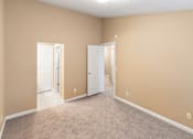 Thumbnail 71 of 73 - A room with two white doors and carpeted flooring at Graymayre Crossing Apartments, Spokane, WA, 99208