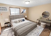 Thumbnail 9 of 12 - A bedroom with a bed, desk, and window.