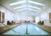 Thumbnail 1 of 73 - A large indoor swimming pool with a skylight above it at Graymayre Crossing Apartments, Spokane, WA, 99208