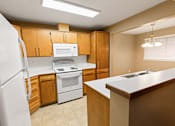 Thumbnail 16 of 73 - A kitchen with a white refrigerator, white stove, and white oven at Graymayre Crossing Apartments, Spokane, WA, 99208
