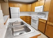 Thumbnail 18 of 73 - A kitchen with a sink and a refrigerator at Graymayre Crossing Apartments, WA, 99208