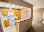 Thumbnail 20 of 73 - A kitchen with a refrigerator, stove, and microwave at Graymayre Crossing Apartments, Spokane, WA